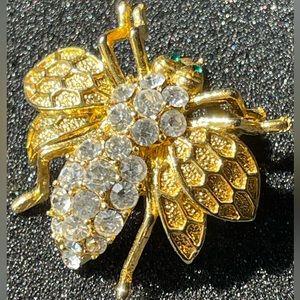 Vintage bee pin with CZ green eyes. C clasp.